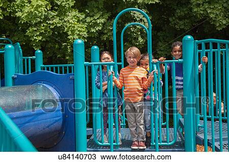 Portrait of four boys and girls on playground climbing frame View Large Photo Image Stock Image - Portrait of four boys and girls on playground climbing frame. Fotosearch