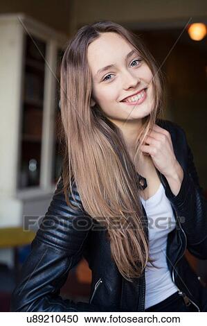 Portrait of happy mid adult woman sitting in cafe View Large Photo Image Stock Image - Portrait of happy mid adult woman sitting in cafe. Fotosearch