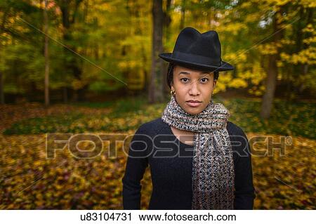 Portrait of mid adult woman wearing trilby and scarf in autumn forest View Large Photo Image Stock Image - Portrait of mid adult woman wearing trilby and scarf in autumn forest. Fotosearch