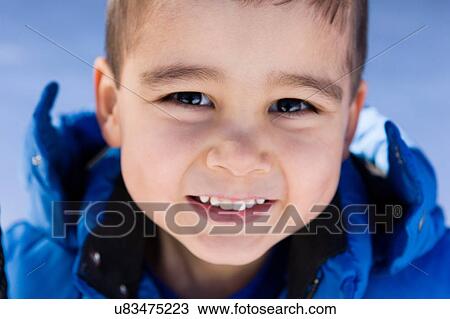 Stock Image - Portrait of preschool boy looking at camera smiling. Fotosearch