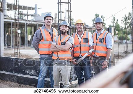 Stock Photograph - Portrait of site manager and building team on construction site. Fotosearch