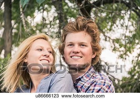 Stock Image - Portrait of teenage girl looking at boyfriend. Fotosearch