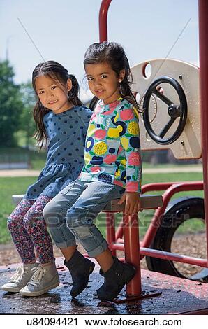 Portrait of two girls sitting on playground climbing frame View Large Photo Image Stock Image - Portrait of two girls sitting on playground climbing frame. Fotosearch