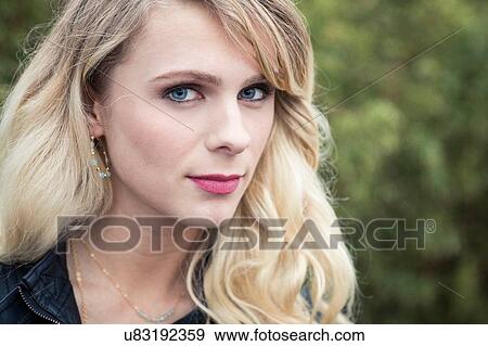 Stock Photo - Portrait of young blonde haired woman looking at camera. Fotosearch