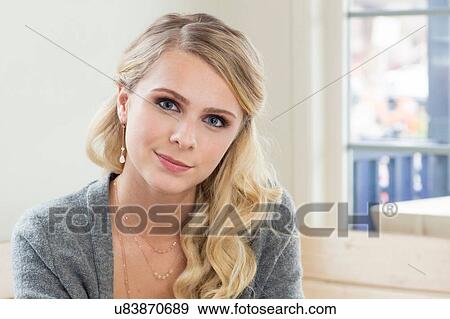 Portrait of young blonde haired woman looking at camera smiling View Large Photo Image Stock Photo - Portrait of young blonde haired woman looking at camera smiling. Fotosearch