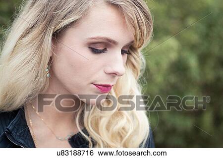 Portrait of young blonde haired woman looking down View Large Photo Image Stock Photograph - Portrait of young blonde haired woman looking down. Fotosearch