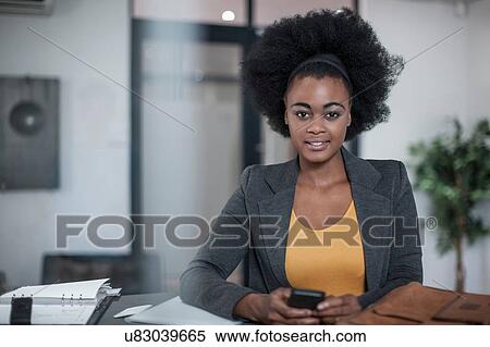Portrait of young businesswomen with smartphone at office reception View Large Photo Image Stock Photography - Portrait of young businesswomen with smartphone at office reception. Fotosearch