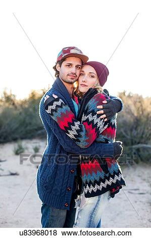 "Portrait of young couple hugging, outdoors" View Large Photo Image Stock Photo - "Portrait of young couple hugging, outdoors". Fotosearch