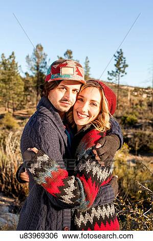 "Portrait of young couple hugging, outdoors" View Large Photo Image Stock Photograph - "Portrait of young couple hugging, outdoors". Fotosearch