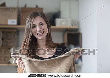 Portrait of young female waitress in cafe holding coffee bean sack View Large Photo Image Stock Photography - Portrait of young female waitress in cafe holding coffee bean sack. Fotosearch