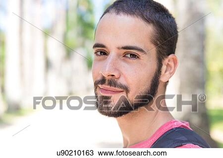 Stock Image - Portrait of young man, smiling. Fotosearch