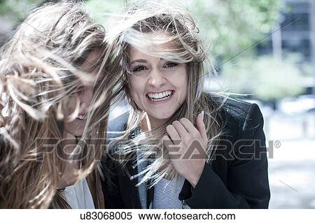 Portrait of young woman and teenage girl with flyaway hair in city View Large Photo Image Stock Photography - Portrait of young woman and teenage girl with flyaway hair in city. Fotosearch