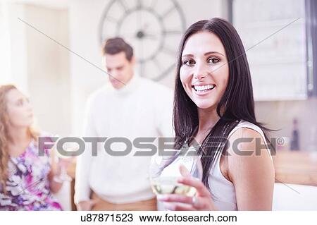 Portrait of young woman drinking wine in kitchen View Large Photo Image Stock Image - Portrait of young woman drinking wine in kitchen. Fotosearch