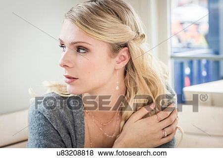 Portrait of young woman hand on shoulder looking away View Large Photo Image Stock Photo - Portrait of young woman hand on shoulder looking away. Fotosearch