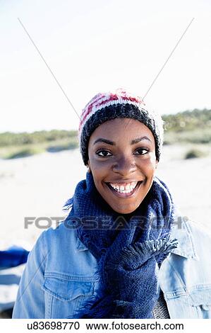 "Portrait of young woman, outdoors, smiling" View Large Photo Image Stock Image - "Portrait of young woman, outdoors, smiling". Fotosearch