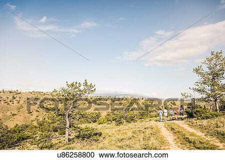 Rear view of teenage and young adult friends walking on dirt track, Bridger, Montana, USA View Large Photo Image Stock Image - Rear view of teenage and young adult friends walking on dirt track, Bridger, Montana, USA. Fotosearch