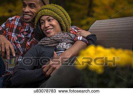 Romantic mid adult couple at dusk in autumn garden View Large Photo Image Stock Image - Romantic mid adult couple at dusk in autumn garden. Fotosearch
