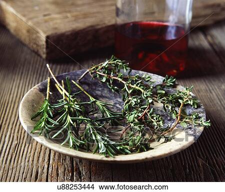 Picture - Rosemary and thyme in vintage bowl, red wine. Fotosearch