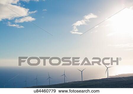 "Row of wind turbines on sunlit coastal cliff, Haleakala, Hawaii, USA" View Large Photo Image Stock Photo - "Row of wind turbines on sunlit coastal cliff, Haleakala, Hawaii, USA". Fotosearch