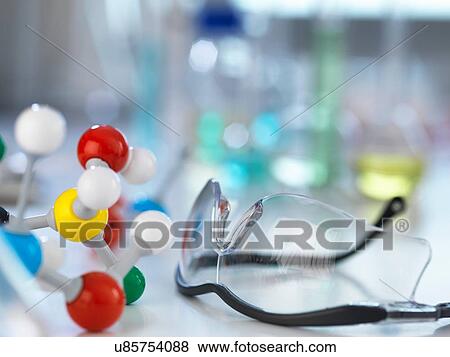 Safety glasses and molecular model on laboratory bench View Large Photo Image Stock Photo - Safety glasses and molecular model on laboratory bench. Fotosearch