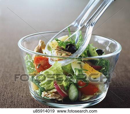 Salad, olives, tuna, tomatoes, cucumber, egg, lettuce, rocket, red onions, green beans in glass bowl with glass spoons View Large Photo Image Stock Photo - Salad, olives, tuna, tomatoes, cucumber, egg, lettuce, rocket, red onions, green beans in glass bowl with glass spoons. Fotosearch