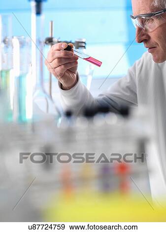 Stock Photo - Scientist preparing chemical experiment in laboratory. Fotosearch