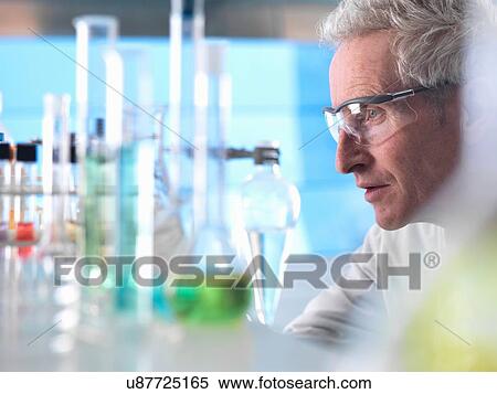 Stock Photography - Scientist preparing chemical experiment in laboratory. Fotosearch