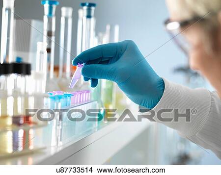 Picture - Scientist testing DNA sample of human in laboratory. Fotosearch