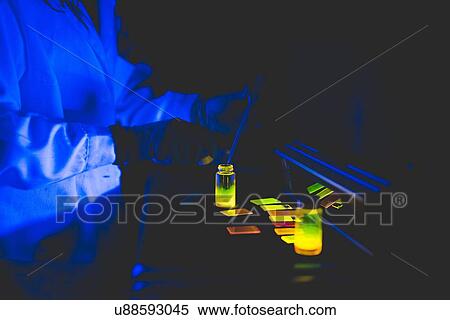 Scientist using fluorescence lamp, checking the fluorescence of different concentrations of dye on hybrid film View Large Photo Image Stock Photography - Scientist using fluorescence lamp, checking the fluorescence of different concentrations of dye on hybrid film. Fotosearch
