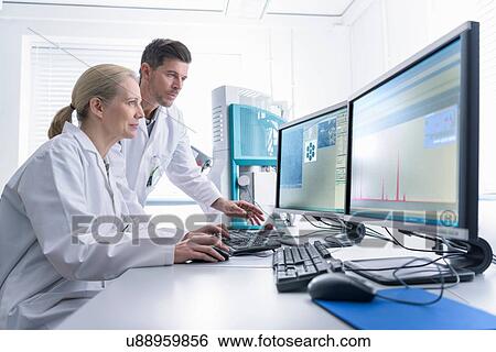 Scientists with electron microscope studying metal structure View Large Photo Image Stock Photograph - Scientists with electron microscope studying metal structure. Fotosearch