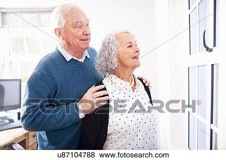 Senior couple in office looking out of window smiling View Large Photo Image Stock Photo - Senior couple in office looking out of window smiling. Fotosearch