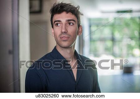 Stock Image - Serious young businessman in office. Fotosearch