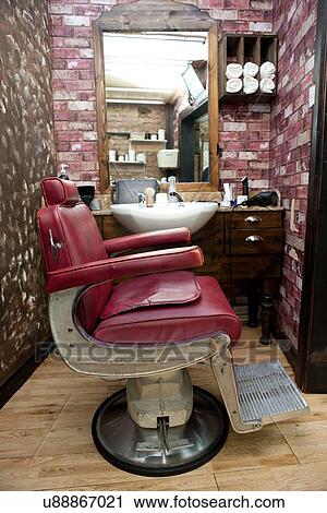 Side view of burgundy leather chair in barbershop View Large Photo Image Stock Image - Side view of burgundy leather chair in barbershop. Fotosearch