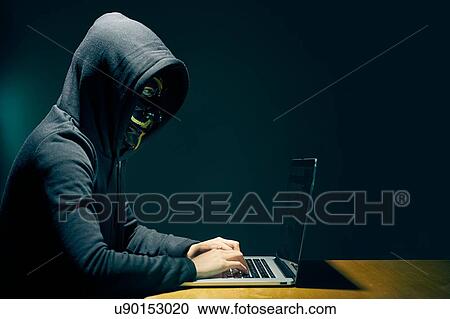 Side view of person wearing hooded top and Guy Fawkes face mask using laptop View Large Photo Image Stock Image - Side view of person wearing hooded top and Guy Fawkes face mask using laptop. Fotosearch