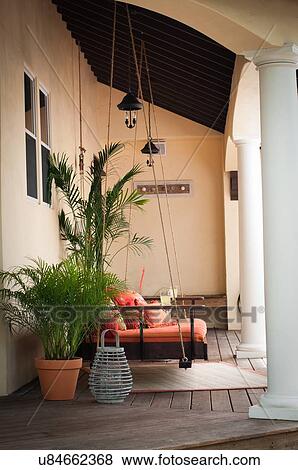 Stock Photo - Side view of swing seat on porch. Fotosearch
