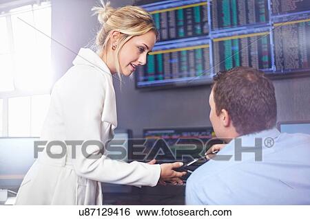 Side view of young business woman in office having discussion with colleague View Large Photo Image Stock Photograph - Side view of young business woman in office having discussion with colleague. Fotosearch