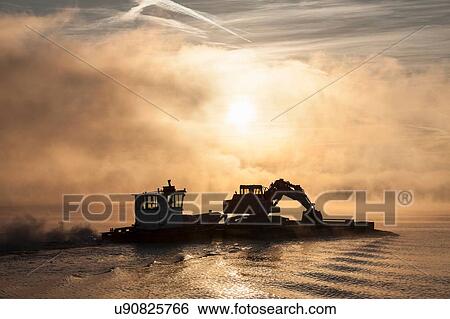 Stock Photograph - Silhouette of boat on Lake Maggiore, Piedmont, Lombardy, Italy. Fotosearch