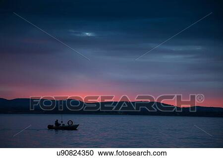 Silhouette of small boat on Lake Maggiore, Piedmont, Lombardy, Italy View Large Photo Image Stock Image - Silhouette of small boat on Lake Maggiore, Piedmont, Lombardy, Italy. Fotosearch