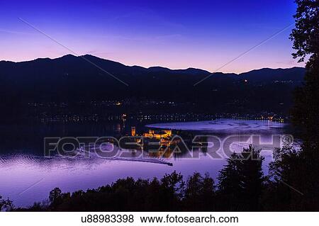Stock Photo - Silhouetted view of Lake Orta at night, Orta San Giulio, Piedmont, Italy. Fotosearch