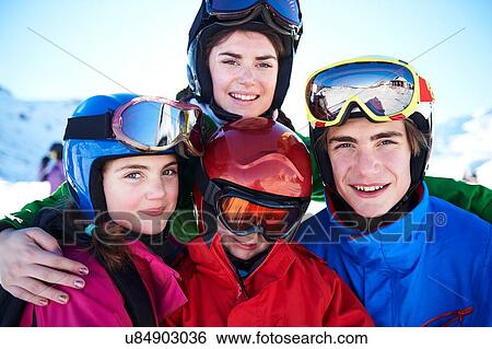 Stock Photograph - Sisters and brothers on skiing holiday. Fotosearch