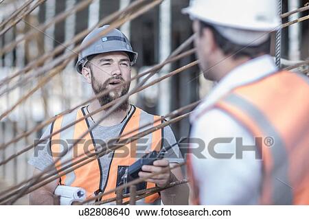 Site manager and builder discussing steel rods on construction site View Large Photo Image Stock Image - Site manager and builder discussing steel rods on construction site. Fotosearch