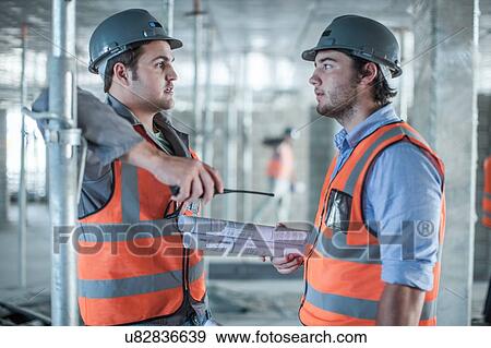 Site manager and builder discussing blueprint on construction site View Large Photo Image Stock Photo - Site manager and builder discussing blueprint on construction site. Fotosearch