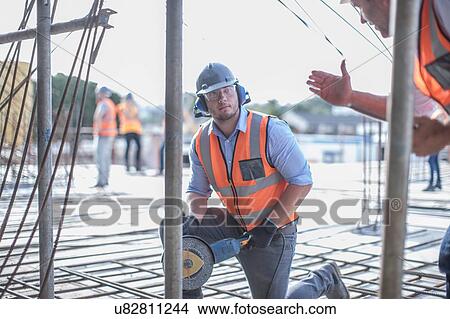 Site manager explaining to builder on construction site View Large Photo Image Picture - Site manager explaining to builder on construction site. Fotosearch