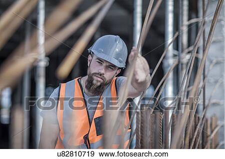 Stock Photo - Site manager signaling with hand on construction site. Fotosearch