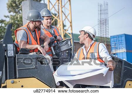 Site manager talking with steamroller drivers about blueprint on construction site View Large Photo Image Picture - Site manager talking with steamroller drivers about blueprint on construction site. Fotosearch