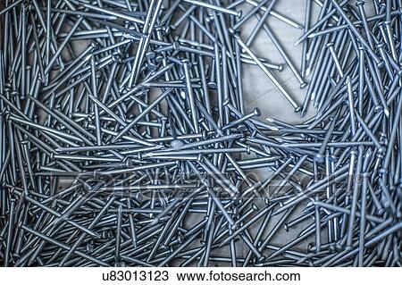 Stock Image - Stack of silver metal nails. Fotosearch
