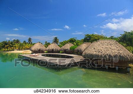 Stock Photograph - "Stilted waterfront chalets and boardwalk, St. Georges Caye, Belize, Central America". Fotosearch
