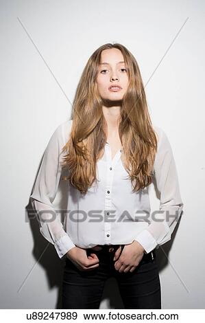 Studio portrait of confident mid adult woman standing against white background View Large Photo Image Stock Photo - Studio portrait of confident mid adult woman standing against white background. Fotosearch
