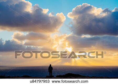"Sunset over ocean, man standing on rocks, looking at view, San Diego, California, USA" View Large Photo Image Stock Image - "Sunset over ocean, man standing on rocks, looking at view, San Diego, California, USA". Fotosearch