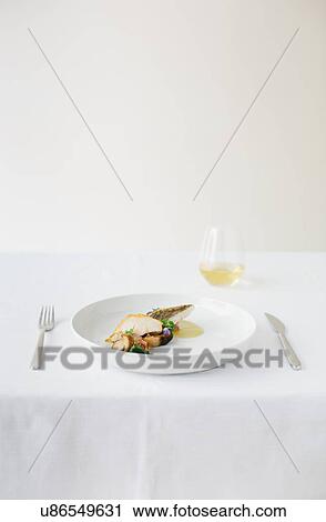 Table setting with plate of fish and mushrooms View Large Photo Image Stock Image - Table setting with plate of fish and mushrooms. Fotosearch